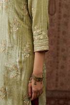 Soft green silk velvet kurta set with gold gota and zari embroidery butas and heavy borders at hem.