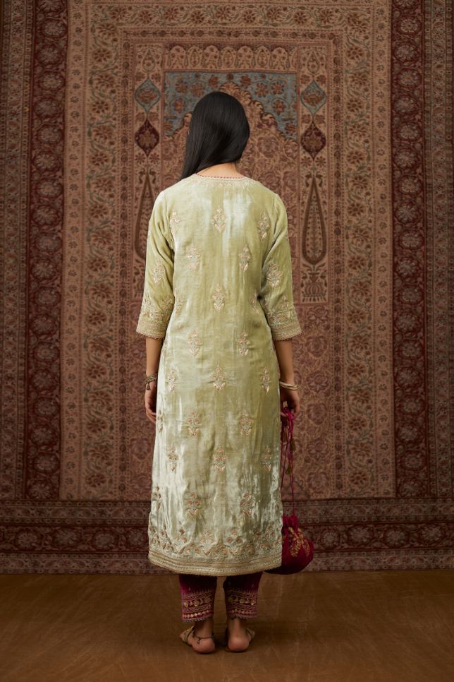 Soft green silk velvet kurta set with gold gota and zari embroidery butas and heavy borders at hem.
