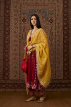 Fuchsia silk velvet straight kurta set with all over gold gota and zari embroidery.