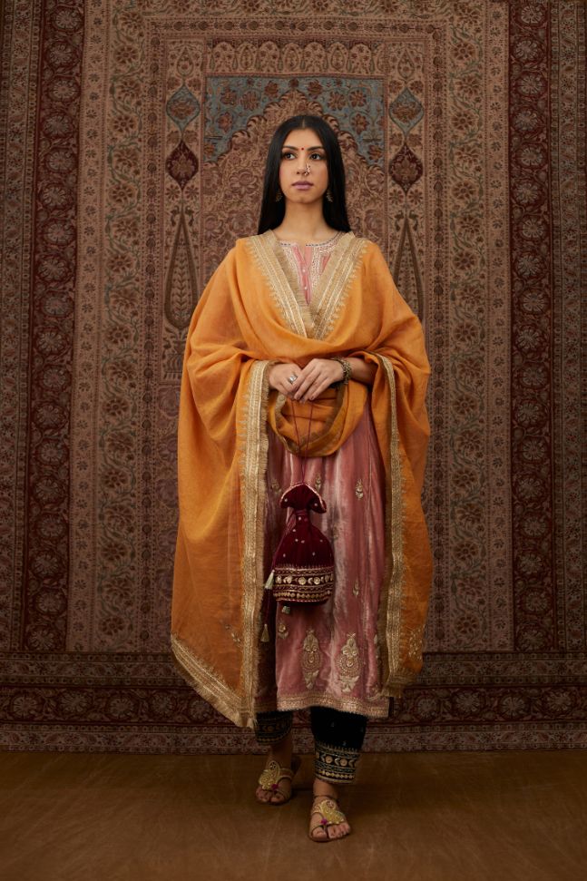 Dusty pink silk velvet kurta set with side panels, highlighted with gold gota and zari embroidery.