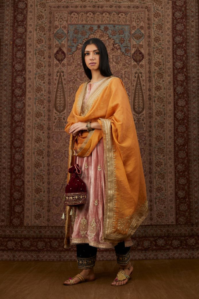 Dusty pink silk velvet kurta set with side panels, highlighted with gold gota and zari embroidery.
