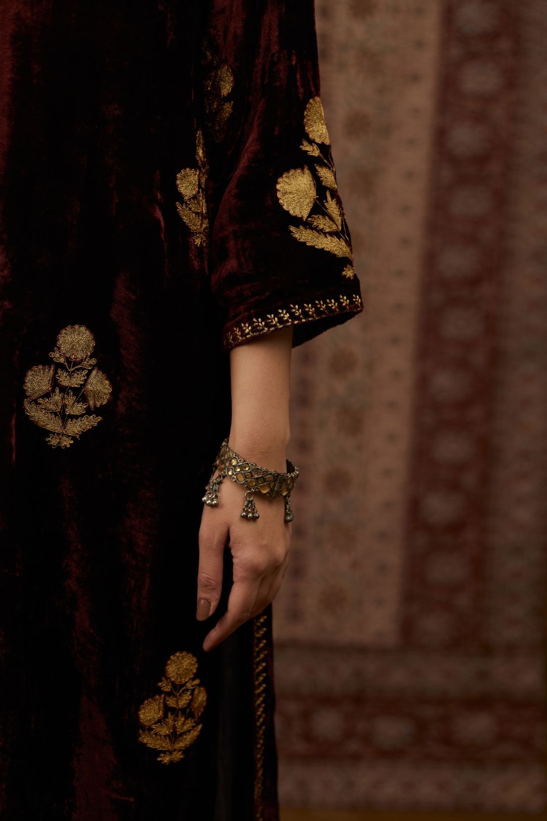 Maroon silk velvet straight kurta set with all over gold zari embroidery butas.