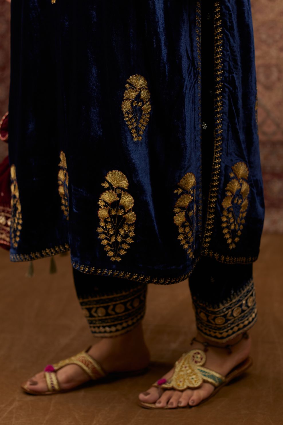 Navy blue silk velvet straight kurta set with all over gold zari embroidery butas and round neckline.