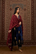 Navy blue silk velvet straight kurta set with all over gold zari embroidery butas and round neckline.