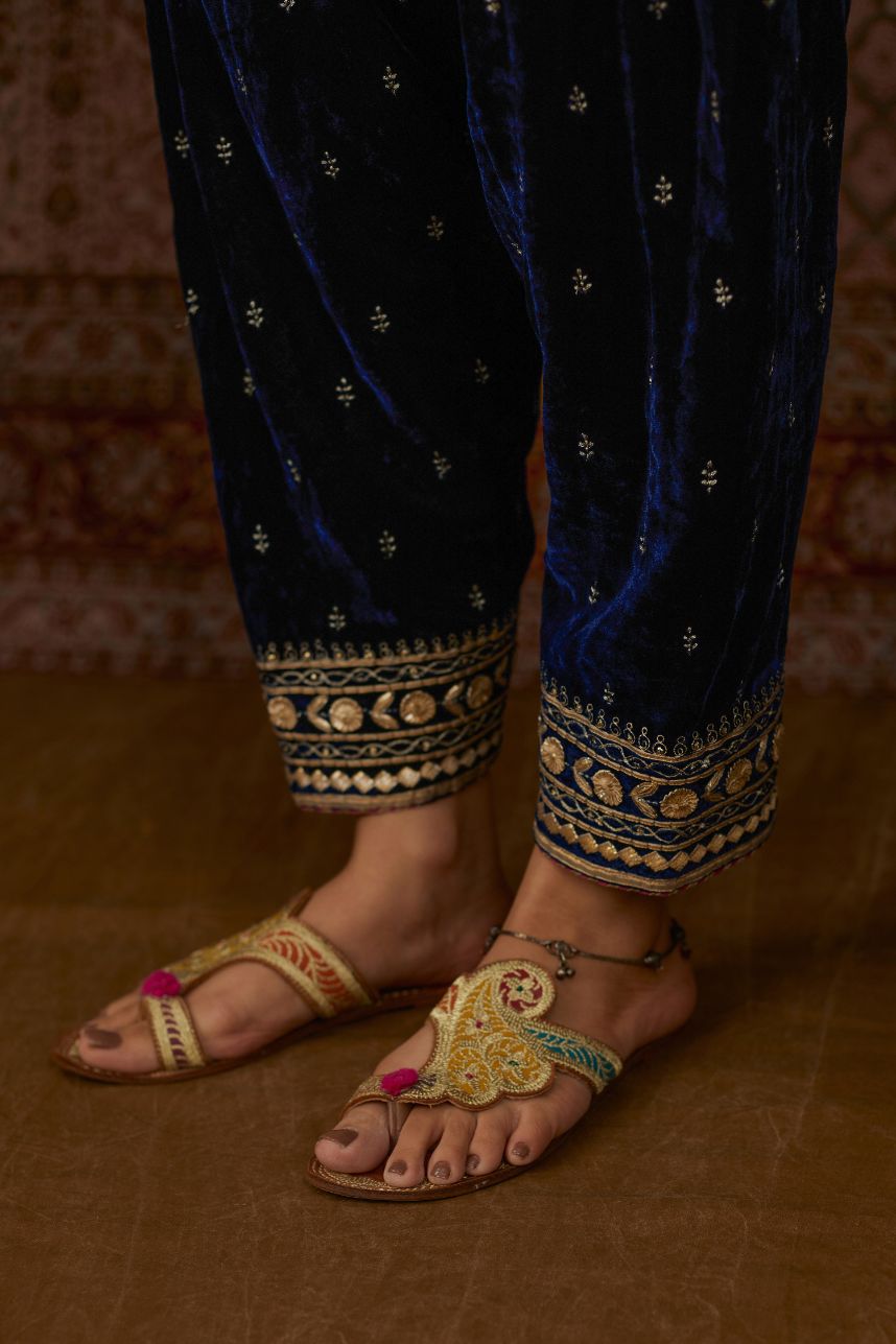 Navy silk velvet narrow salwar with gold gota and zari embroidery at the bottom and delicate butis all over (Salwar)