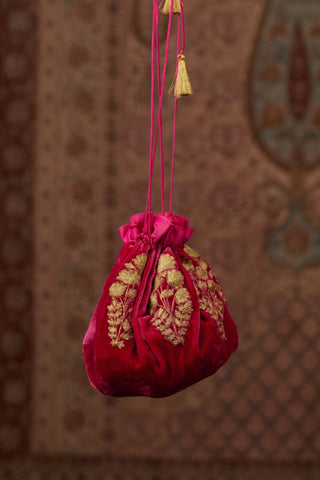 Silk Velvet round potli fully lined with silk. It has gold zari flower butas placed all around the circumference (Potli)
