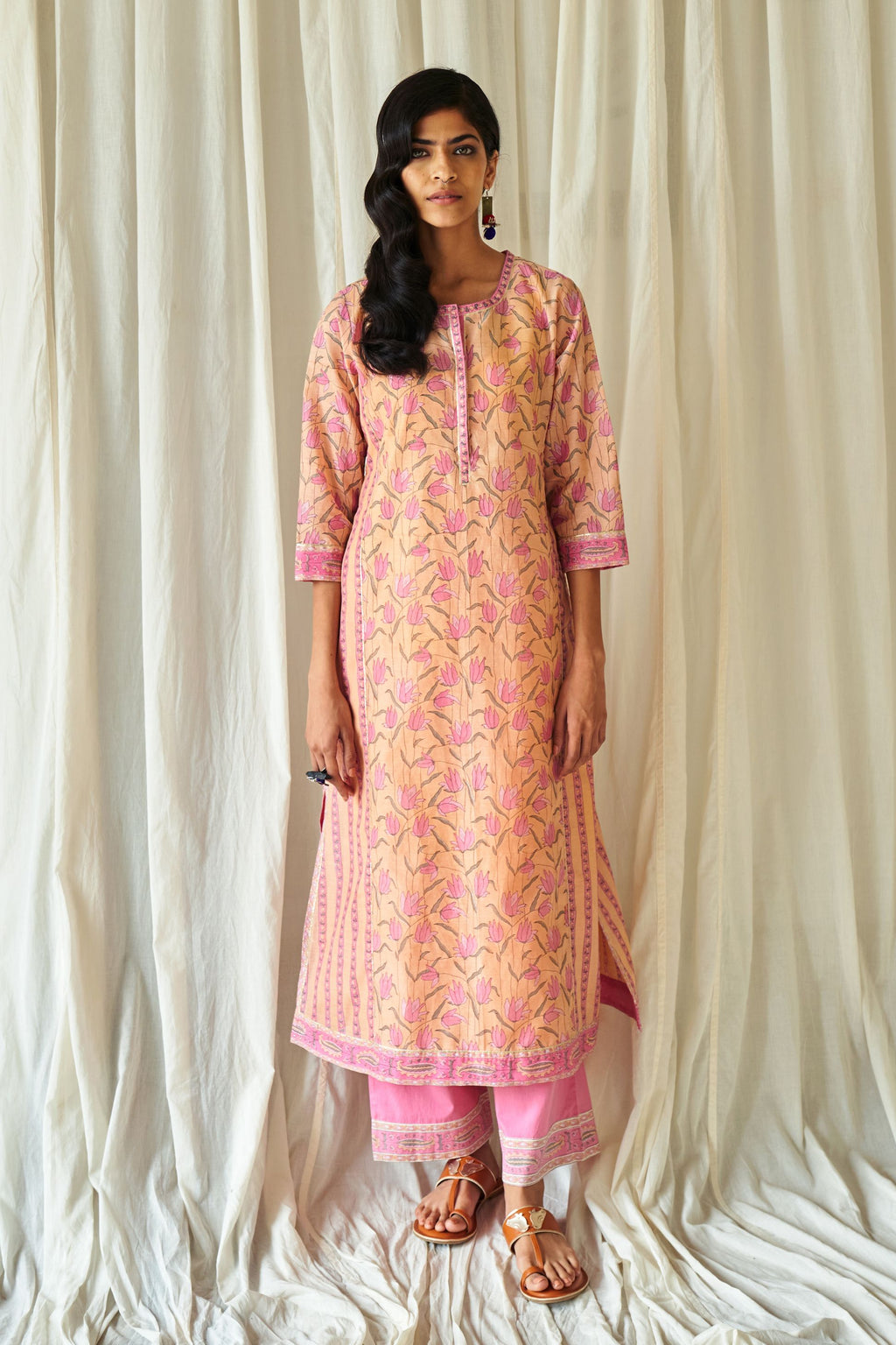 Peach straight kurta in assorted hand block prints with front placket and side panels.