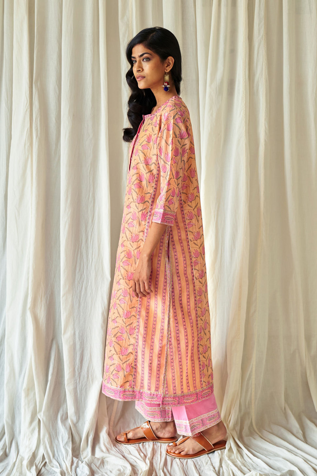 Peach straight kurta in assorted hand block prints with front placket and side panels.