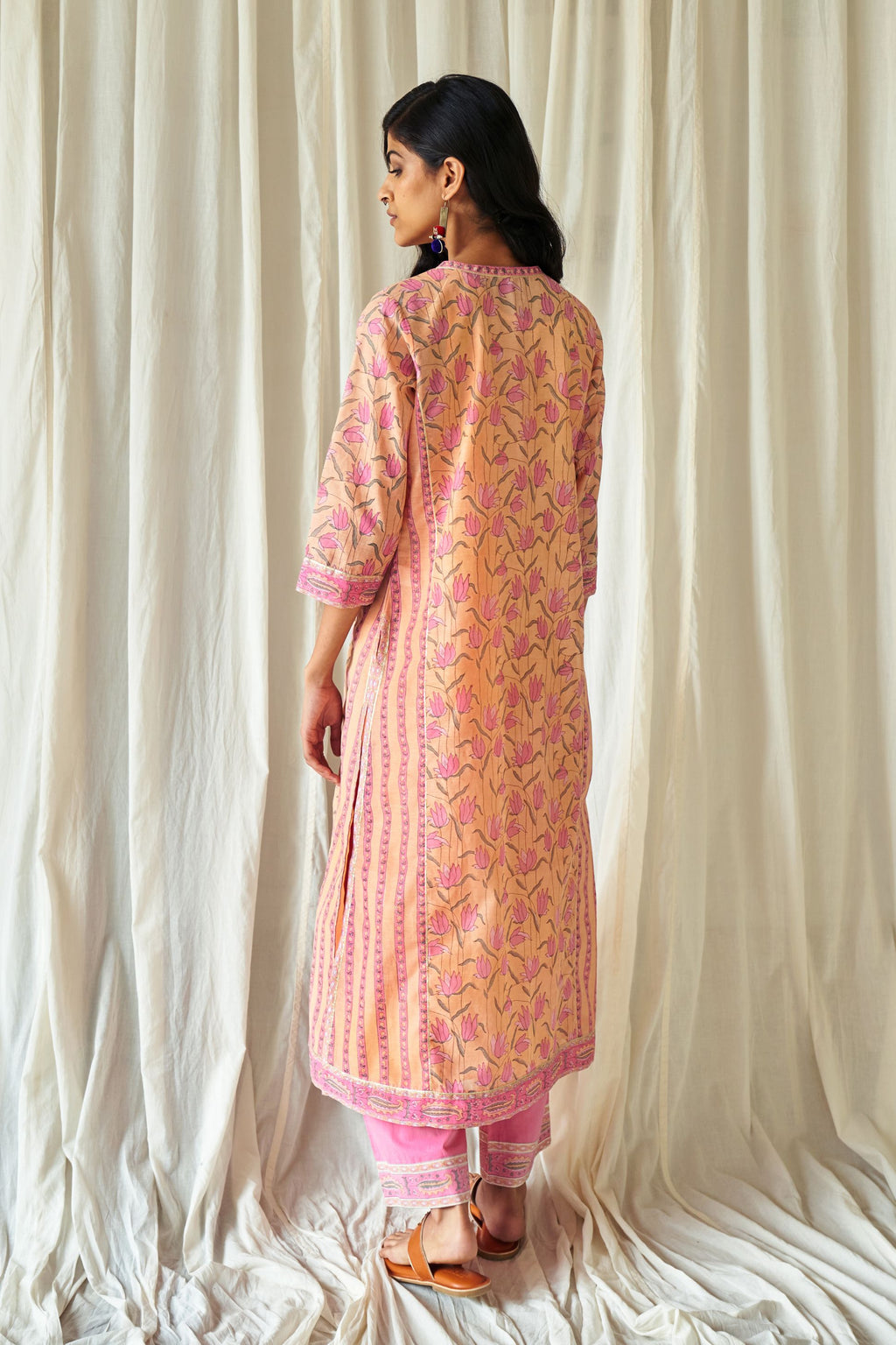 Peach straight kurta in assorted hand block prints with front placket and side panels.