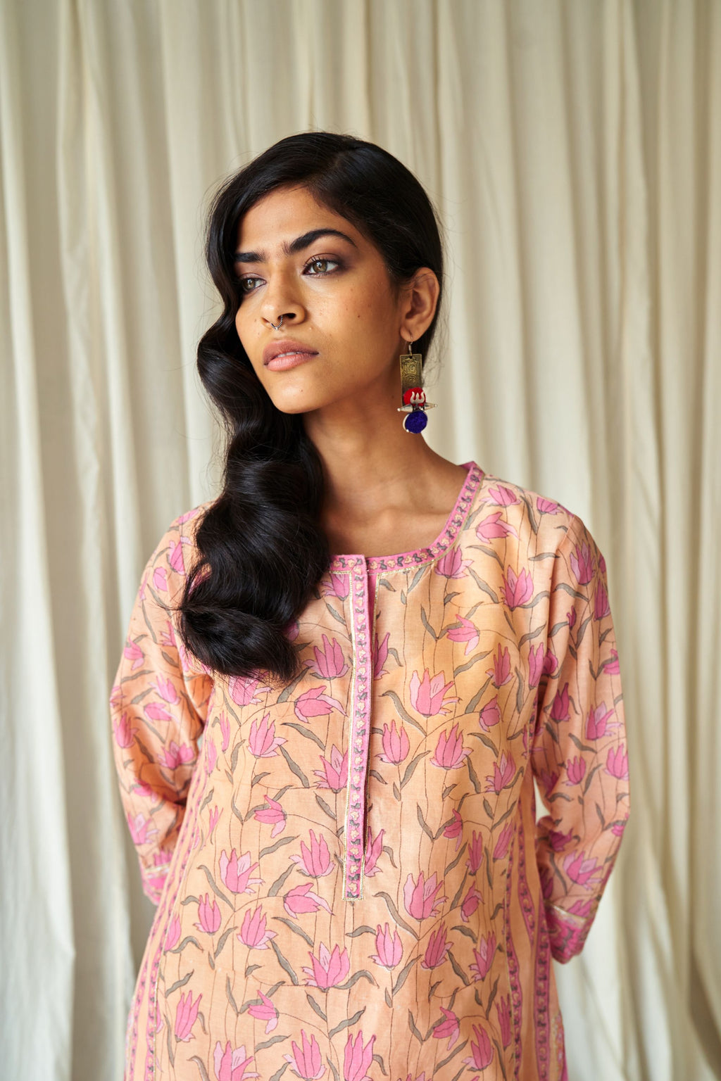 Peach straight kurta in assorted hand block prints with front placket and side panels.