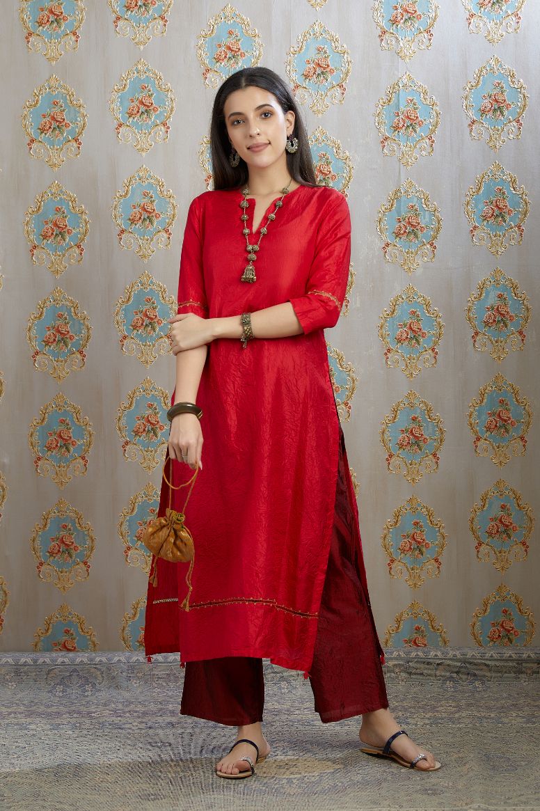 Red hand crushed silk kurta with pulled thread embroidery, paired with hand crushed silk pants.