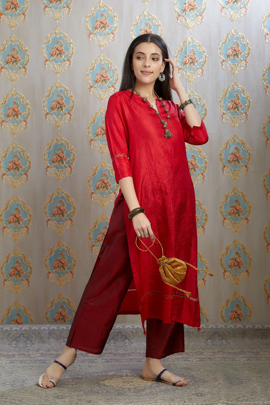 Red hand crushed silk kurta with pulled thread embroidery, paired with hand crushed silk pants.