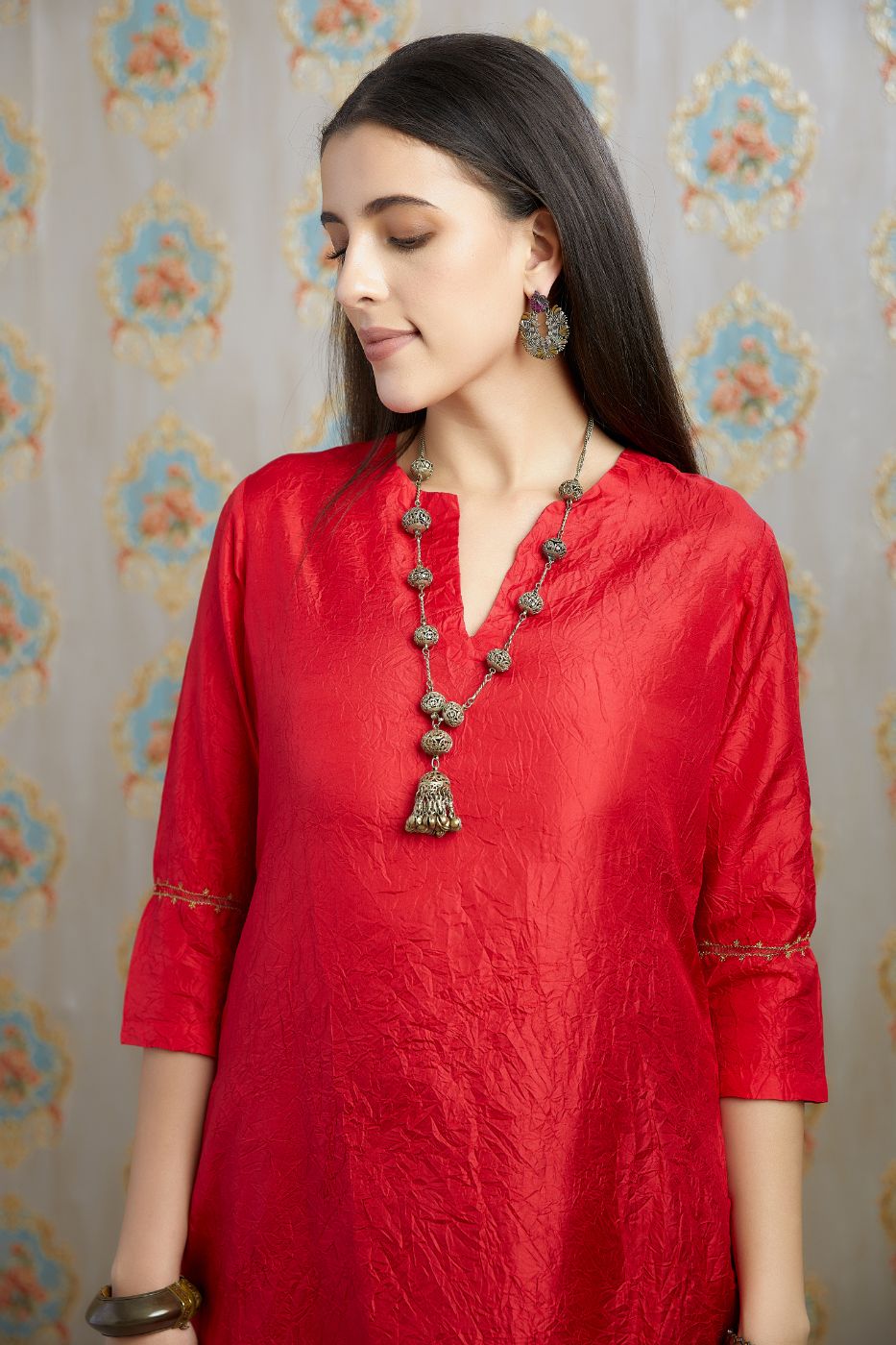 Red hand crushed silk kurta with pulled thread embroidery, paired with hand crushed silk pants.