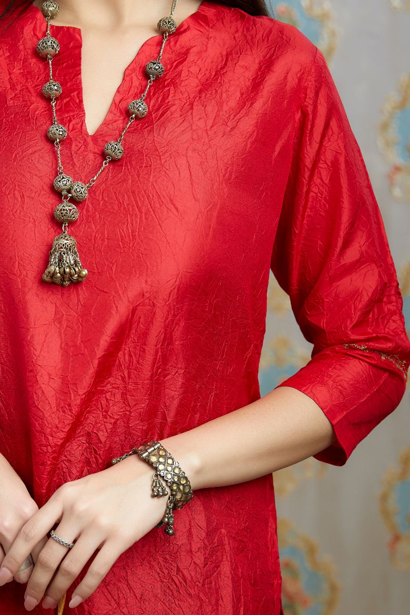 Red hand crushed silk kurta with pulled thread embroidery, paired with hand crushed silk pants.