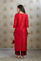 Red hand crushed silk kurta with pulled thread embroidery, paired with hand crushed silk pants.