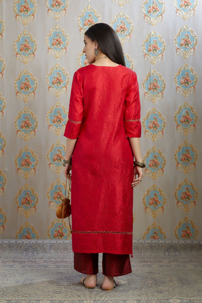 Red hand crushed silk kurta with pulled thread embroidery, paired with hand crushed silk pants.