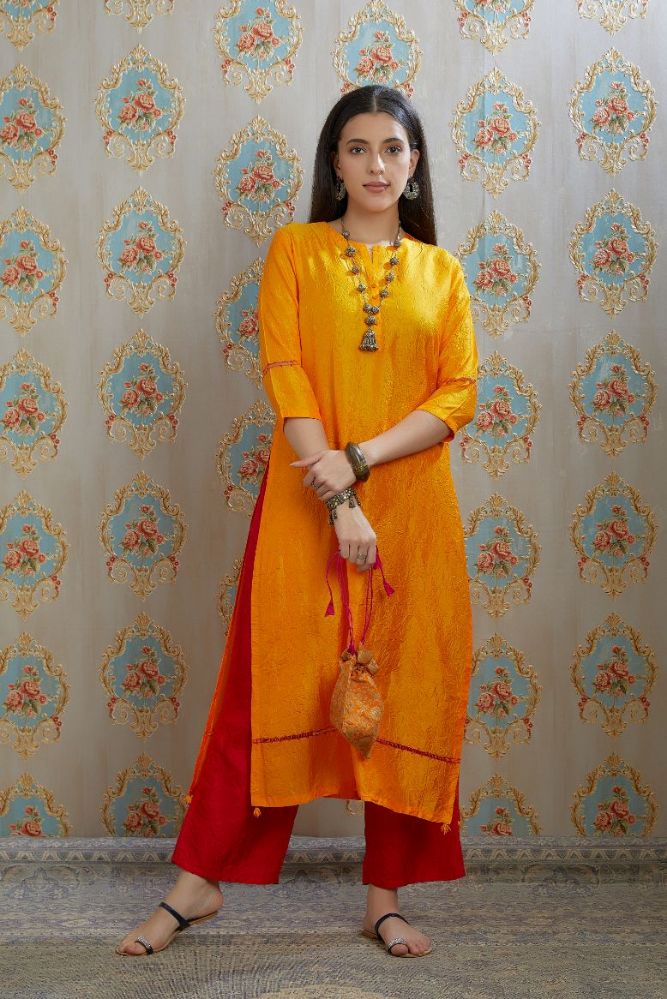 Yellow hand crushed silk kurta with pulled thread embroidery, paired with hand crushed silk pants.