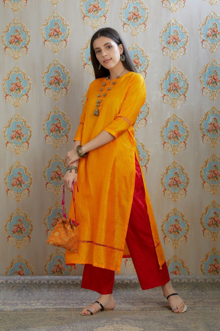 Yellow hand crushed silk kurta with pulled thread embroidery, paired with hand crushed silk pants.