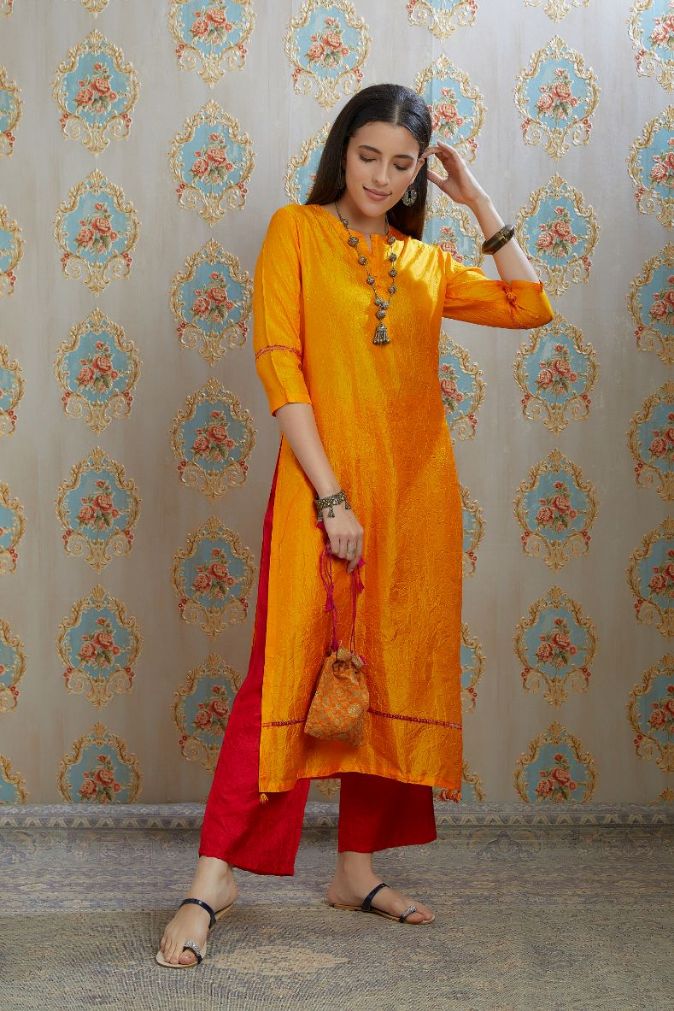 Yellow hand crushed silk kurta with pulled thread embroidery, paired with hand crushed silk pants.