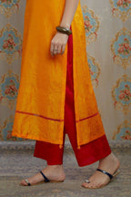 Yellow hand crushed silk kurta with pulled thread embroidery, paired with hand crushed silk pants.