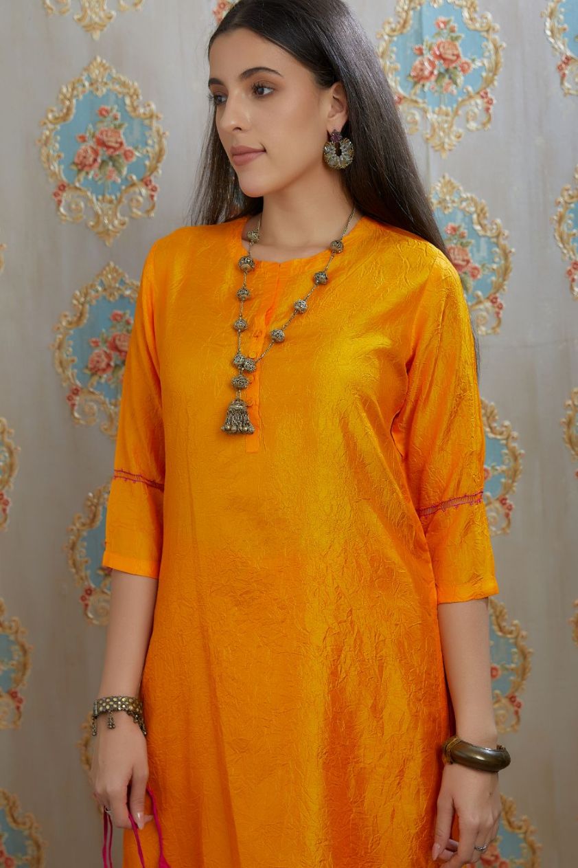 Yellow hand crushed silk kurta with pulled thread embroidery, paired with hand crushed silk pants.
