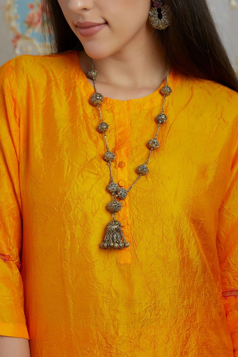 Yellow hand crushed silk kurta with pulled thread embroidery, paired with hand crushed silk pants.