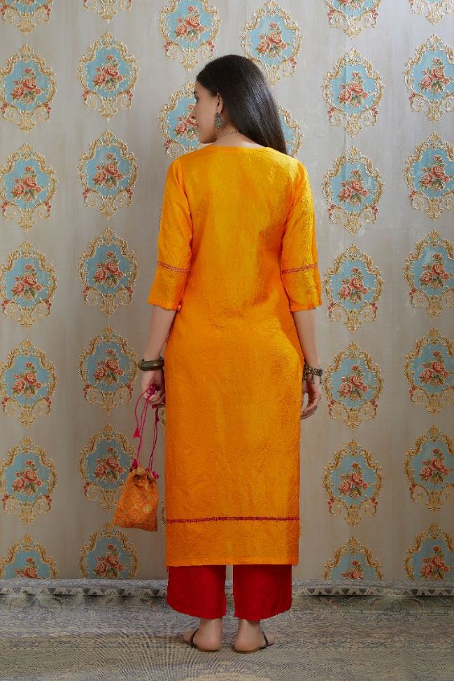 Yellow hand crushed silk kurta with pulled thread embroidery, paired with hand crushed silk pants.