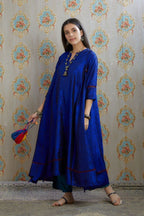 Asymmetric hem blue hand crushed silk kurta with pulled thread embroidery, paired with hand crushed silk pants.