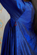 Asymmetric hem blue hand crushed silk kurta with pulled thread embroidery, paired with hand crushed silk pants.