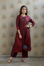 Maroon hand crushed silk kurta with contrasting side panels, paired with hand crushed straight silk pants.