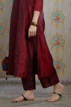 Maroon hand crushed silk kurta with contrasting side panels, paired with hand crushed straight silk pants.