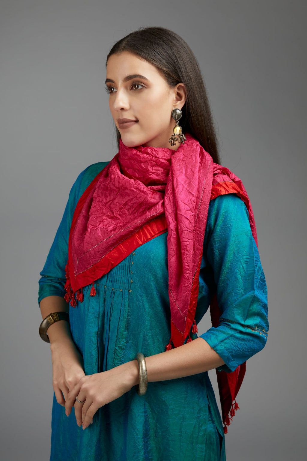 Hand crushed fuchsia silk scarf with contrasting red silk fabric at edges joint with gold zari faggoting