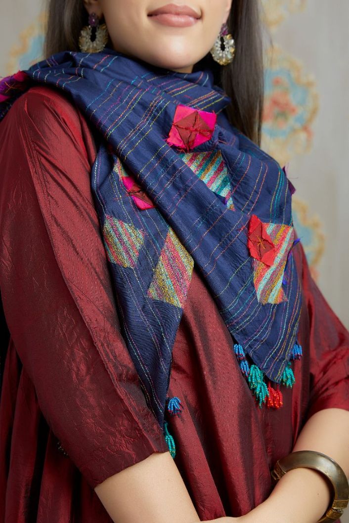 Asymmetric hem maroon hand crushed silk kurta set highlighted with beaded tassels
