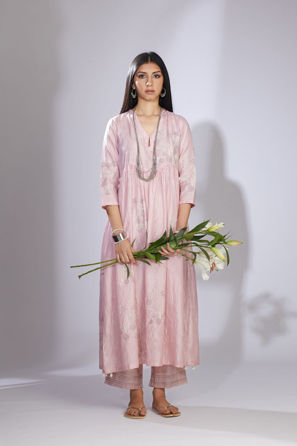 Pink hand-crushed silk kurta set with wavy empire waistline and gathers, highlighted with delicate sequins embroidery