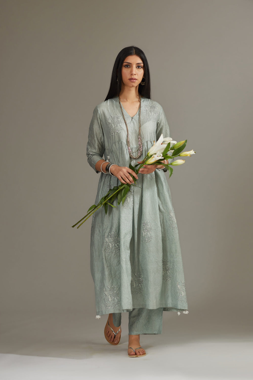 Sea blue hand-crushed silk kurta set with wavy empire waistline and gathers, highlighted with delicate sequins embroidery
