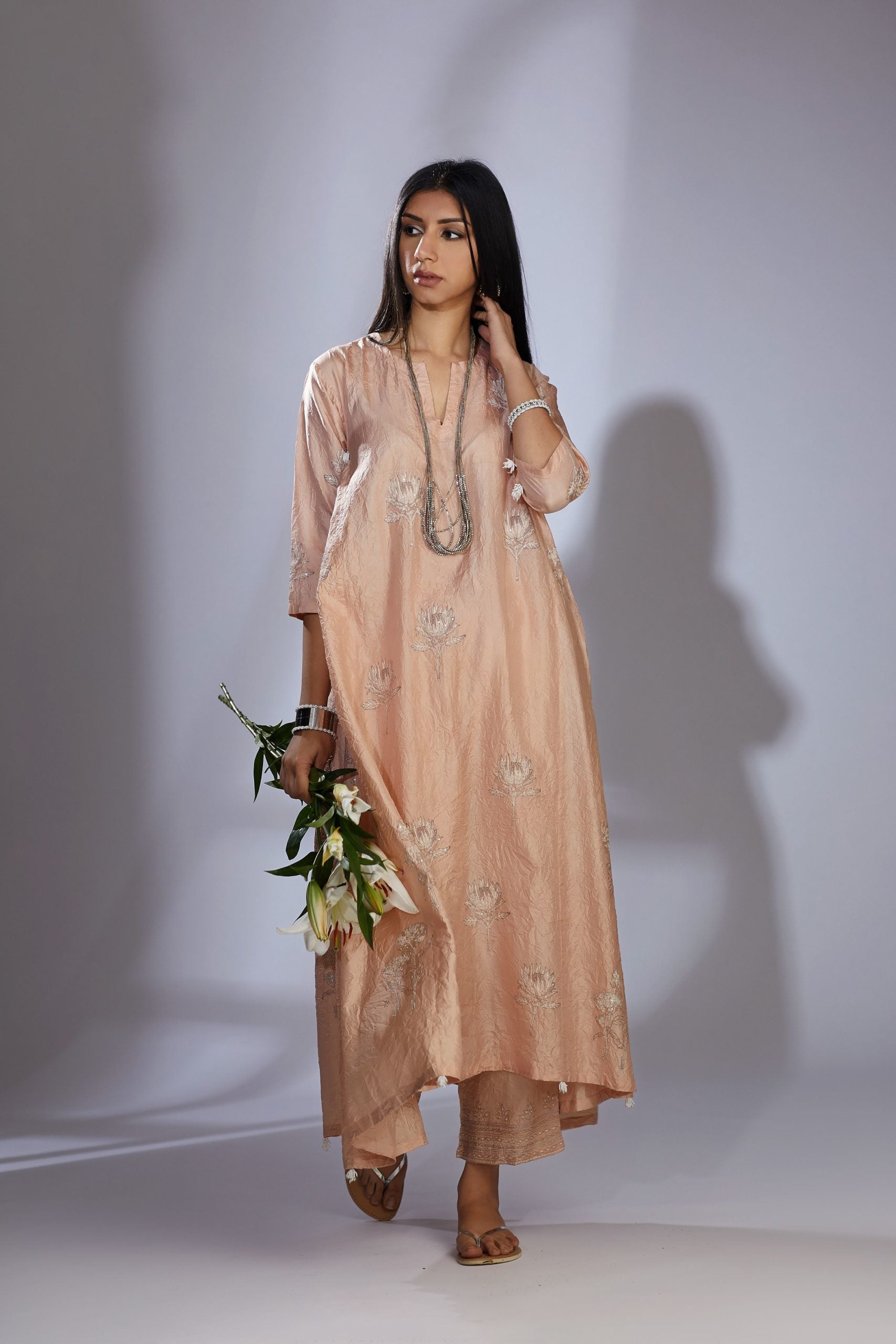 Peach silk hand-crushed asymmetric hem kurta set with block prints embellished with sequins