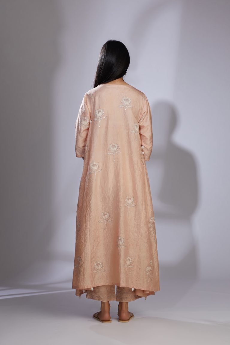 Peach silk hand-crushed asymmetric hem kurta set with block prints embellished with sequins