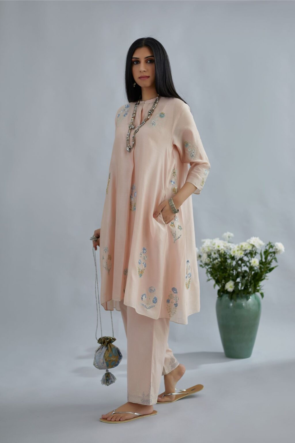Seashell pink short kurta set with printed floral applique work, highlighted with zari embroidery and sequins.