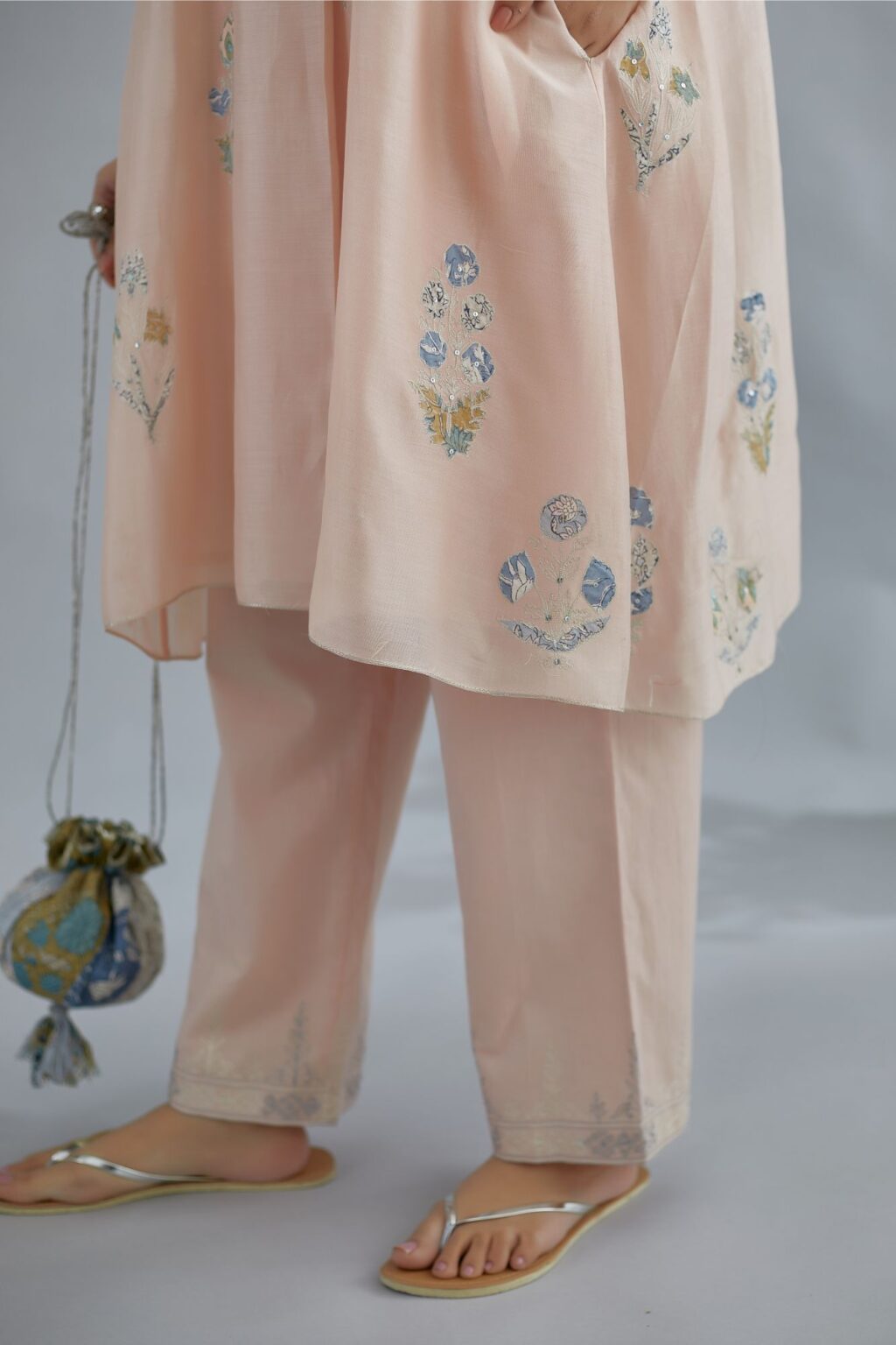 Seashell pink short kurta set with printed floral applique work, highlighted with zari embroidery and sequins.
