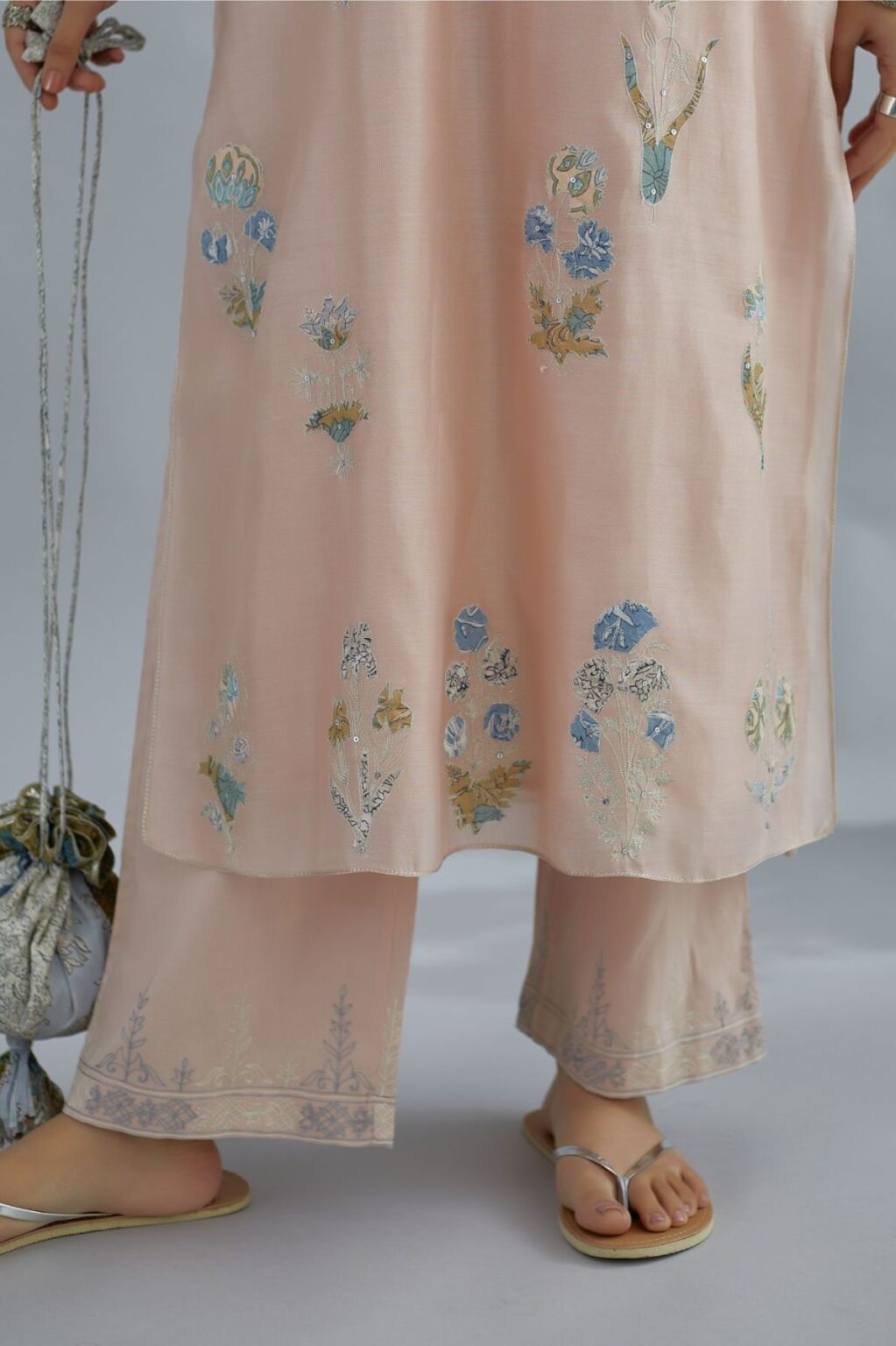 Seashell pink silk Chanderi straight kurta set with all-over floral applique, highlighted with sequin embroidery and silver zari detail.