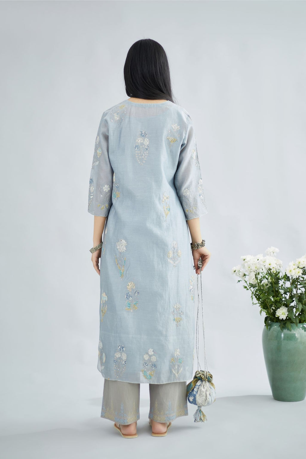 Pigeon blue silk Chanderi straight kurta set with all-over floral applique, highlighted with sequin embroidery and silver zari detail.