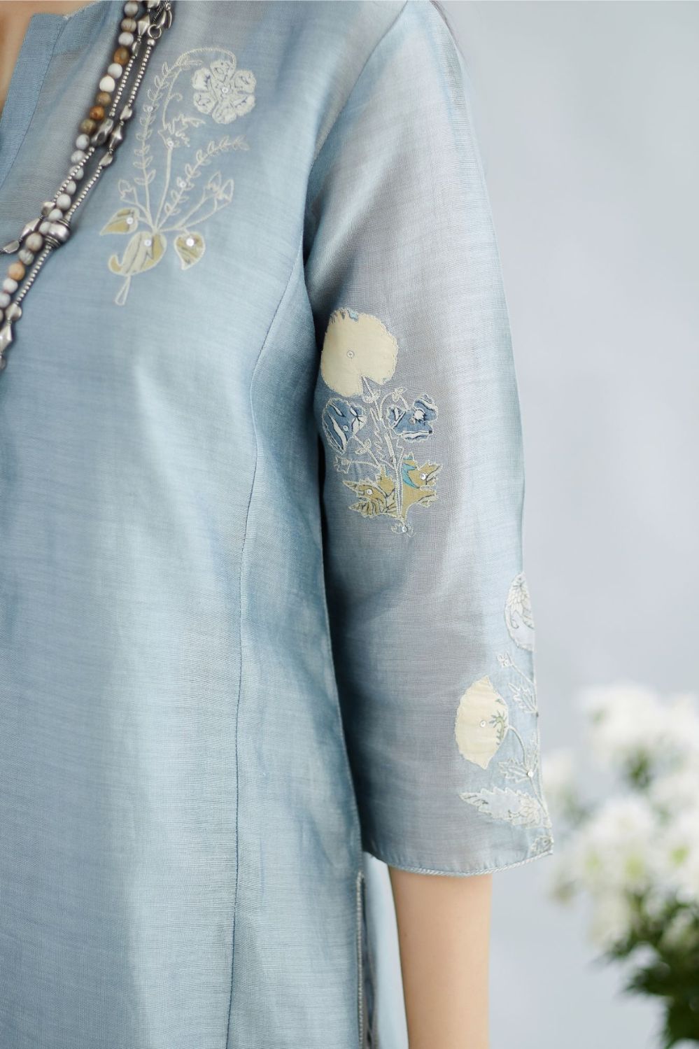 Pigeon blue silk Chanderi straight kurta set with all-over floral assorted print applique, highlighted with sequin and silver zari embroidery.