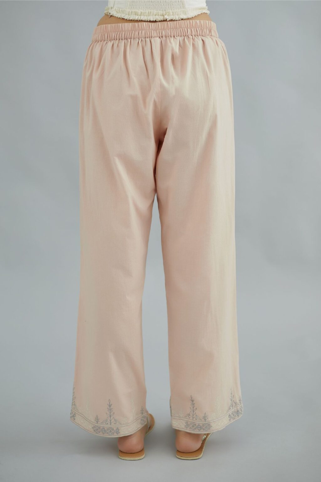 Pink straight cotton pants with thread embroidery at bottom hem